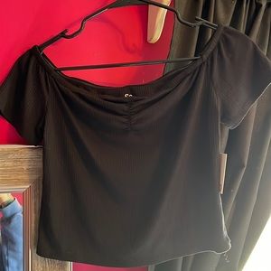 NEW WITH TAGS black crop top. Can be worn off shoulder. Size: Medium